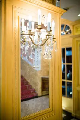 a chandelier in a room with a picture on the wall at Luxury Family Hotel Royal Palace in Prague