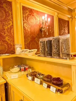 a shelf with donuts and other items on it at Luxury Family Hotel Royal Palace in Prague