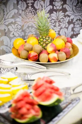 a plate of fruit on a table with a bowl of fruit at Luxury Family Hotel Royal Palace in Prague