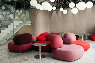 a lobby with red and pink chairs and stairs at Metropol Design Hotel Old Town in Prague