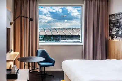 a hotel room with two beds and a tv at Courtyard by Marriott Prague Airport in Prague