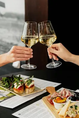 two people are holding glasses of white wine at Courtyard by Marriott Prague Airport in Prague