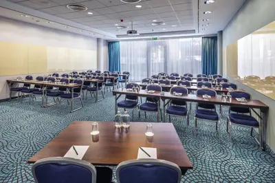 a large room with tables and chairs in it at Courtyard by Marriott Prague City in Prague