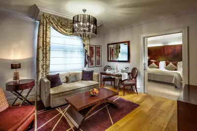 a living room with a couch and a table at The Grand Mark Prague - The Leading Hotels of the World in Prague