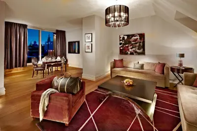a living room with a couch and a table at The Grand Mark Prague - The Leading Hotels of the World in Prague