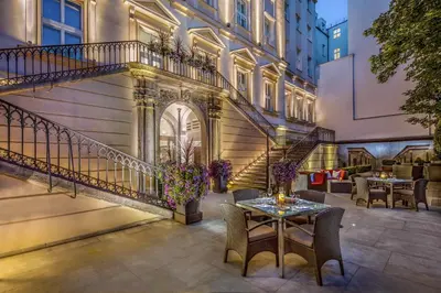 a patio with a table and chairs in front of a building at The Grand Mark Prague - The Leading Hotels of the World in Prague