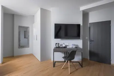 a room with a desk with a chair and a tv at Koruna Hotel in Prague