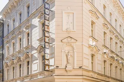 a sign on the side of a building at Koruna Hotel in Prague