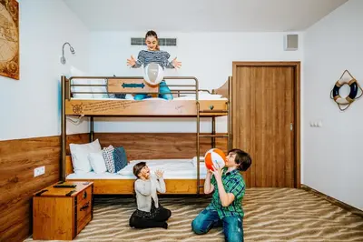 two children playing with a ball in a bedroom at Aquapalace Hotel Prague in Čestlice