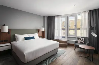 a hotel room with a large bed and a chair at Prague Marriott Hotel in Prague