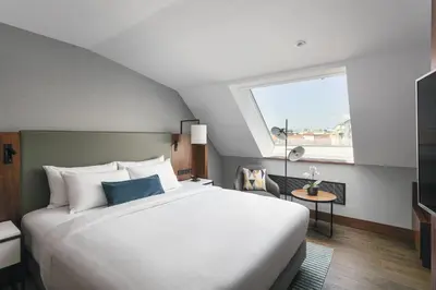 a bedroom with a large white bed and a window at Prague Marriott Hotel in Prague