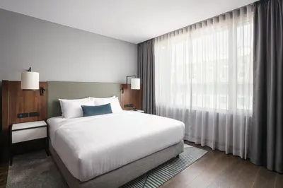 a bedroom with a large bed and a large window at Prague Marriott Hotel in Prague
