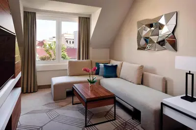 a living room with a couch and a table at Prague Marriott Hotel in Prague