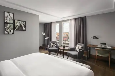 a hotel room with a bed and a desk and chairs at Prague Marriott Hotel in Prague