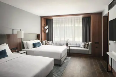 a hotel room with two beds and a couch at Prague Marriott Hotel in Prague