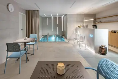 a restaurant with a pool and tables and chairs at Mamaison Residence Downtown Prague in Prague