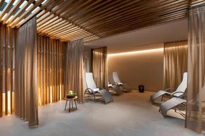 a waiting room with white chairs and windows at Mamaison Residence Downtown Prague in Prague