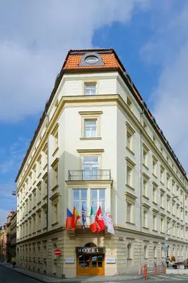 a white building with a clock on top of it at Exe City Park Hotel in Prague