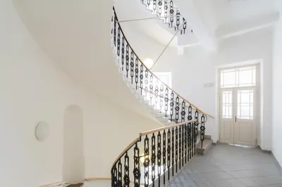 a staircase in a house with white walls and white floors at Exe City Park Hotel in Prague