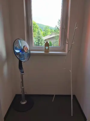 a room with a lamp in front of a window at Apartmán Tony Slapy in Slapy