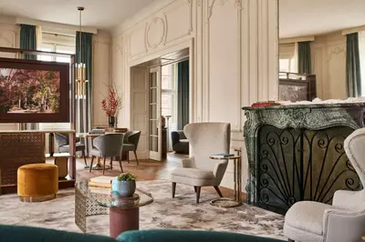 a living room with chairs and a fireplace at Andaz Prague, By Hyatt in Prague