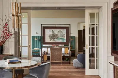 a living room with a table and chairs at Andaz Prague, By Hyatt in Prague