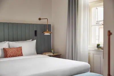 a bedroom with a white bed and a window at Andaz Prague, By Hyatt in Prague