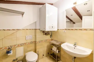 a bathroom with a sink and a toilet at Janackovo - Riverside Residence in Prague