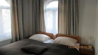 two twin beds in a bedroom with a window at Villa Jinonice in Prague