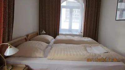 two beds in a bedroom with a window at Villa Jinonice in Prague