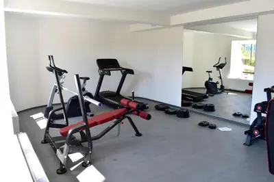 a gym with several tread machines in a room at Airstay Prague apartment: Grebovka in Prague