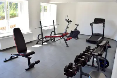 a gym with several exercise equipment in a room at Airstay Prague apartment: Grebovka in Prague