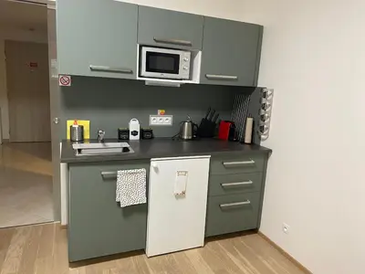 a dresser with a television on top of it at Harfa Apartment 30 in Prague