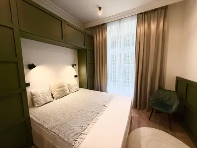 a bedroom with a large bed and a window at Luxury Residence Kmochova in Prague