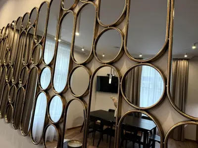a wall of mirrors in a room with a table at Luxury Residence Kmochova in Prague