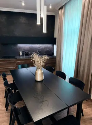 a dining room with a black table and chairs at Luxury Residence Kmochova in Prague