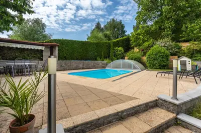 a patio with a swimming pool and a greenhouse at Private summer house with swimming pool, beach bar and pit for football and volleyball in Hvězdonice