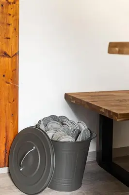 a trash can with a table next to a wall at Private summer house with swimming pool, beach bar and pit for football and volleyball in Hvězdonice