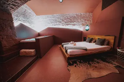 a small room with a bed in a brick room at SPA SPA Letná in Prague