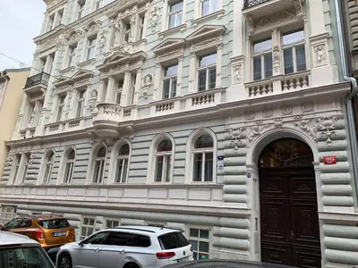 a white car parked in front of a building at Charles Square Prague Apartment in Prague