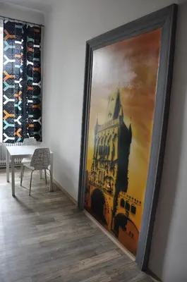 a large painting of a building on the wall at Onefam Home in Prague