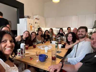 a group of people sitting around a table at Onefam Home in Prague