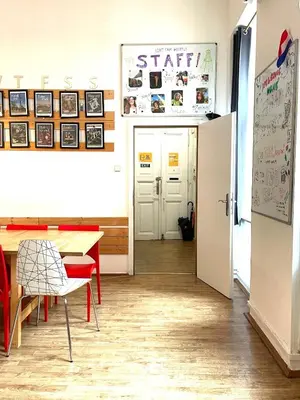 a dining room with a table and a refrigerator at Onefam Home in Prague