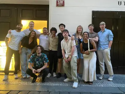 a group of people posing for a picture in front of a building at Onefam Home in Prague