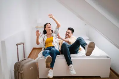 a man and a woman sitting on a bed at NEW GENERATION HOSTEL Prague center in Prague