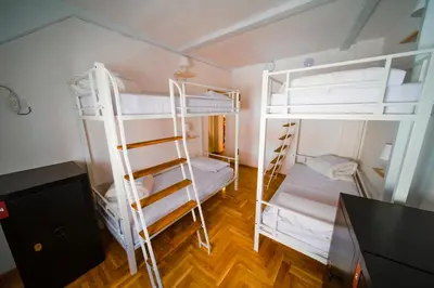 a room with two bunk beds and a desk at NEW GENERATION HOSTEL Prague center in Prague