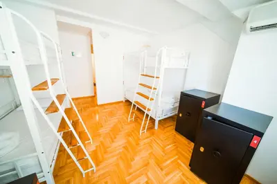 a room with two bunk beds and a desk at NEW GENERATION HOSTEL Prague center in Prague