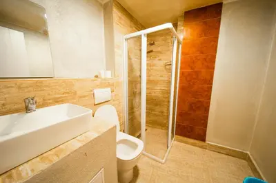 a bathroom with a shower and a toilet and a sink at NEW GENERATION HOSTEL Prague center in Prague
