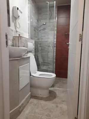 a bathroom with a toilet and a sink and a shower at NEW GENERATION HOSTEL Prague center in Prague