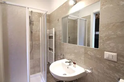 a bathroom with a sink and a shower and a mirror at NEW GENERATION HOSTEL Prague center in Prague
